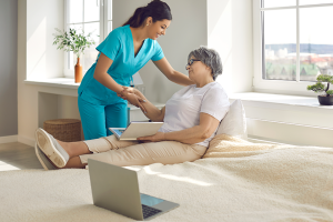 elderly-woman-patient-and-female-nurse-talking-in-hospital